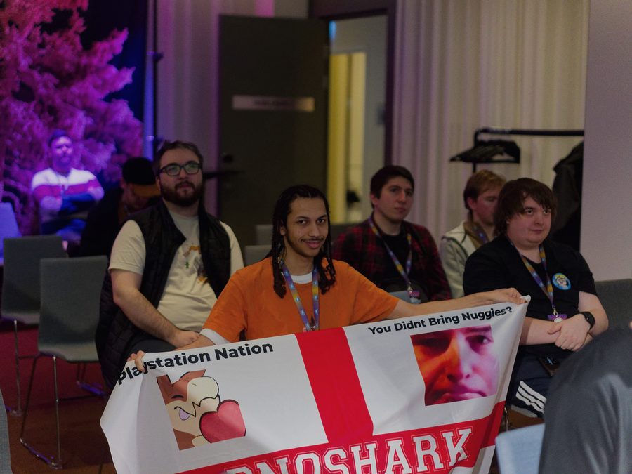 Attendees holding up a community flag